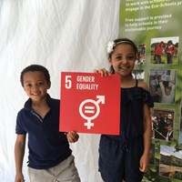 Global Goals 2017 - 6 Boy and girl smiling and holding up a sign which reads "Gender equality"