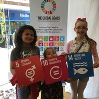 Global Goals 2017 - 9 Three girls holding up signs, "Gender equality", "Reduced inequalities", "Life below water"